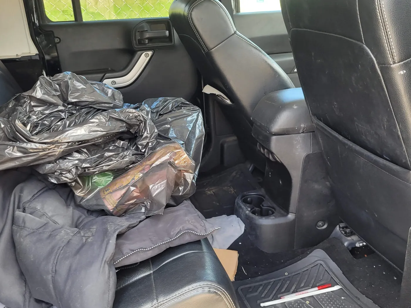 A cluttered vehicle cabin before detailing